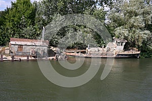 Rusty old ship on the banks of the river