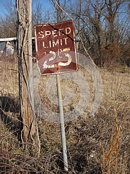 Rusty Old Speed Limit Sign in Abandoned Town