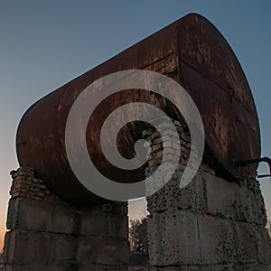 Rusty old tank in dusk,