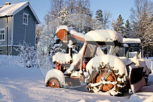 Rusty old tractors left in the snow