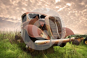 Rusty old truck abandoned in a field