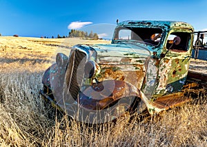 Rusty old truck in a farm field