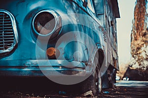 A rusty old truck sits derelict on the city street