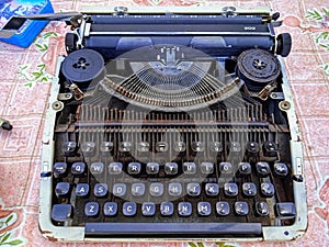 Rusty old typewriter on the floor