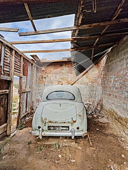 Rusty old vintage car in an abandoned garage