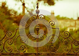 Rusty old wrought iron gate in front of old English Manor House