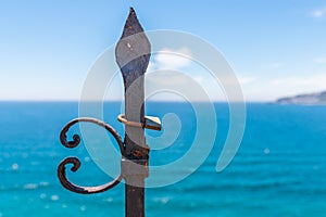 Rusty padlock attached to a balustrade by the sea, a traditional