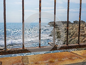 Rusty padlock on a bridge fence and beautiful seaview in Cyprus