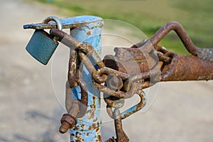 Rusty padlock with chain and screws outside