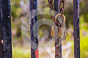 Rusty padlock closing the gate