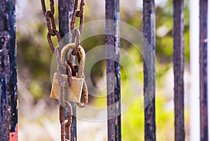 Rusty padlock closing the gate