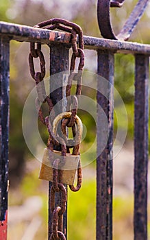 Rusty padlock closing the gate