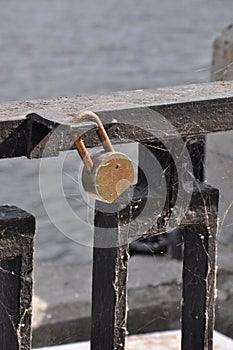 Rusty padlock on a cobweb parapet