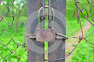 Rusty padlock at gate