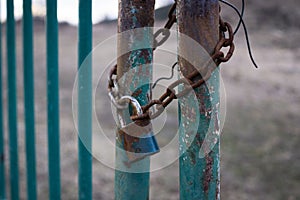 Padlock on the gate in the meadow fence. Slovakia