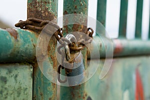 Padlock on the gate in the meadow fence. Slovakia