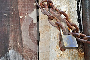 Rusty padlock and metal chain