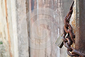 Rusty padlock and metal chain