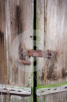 Rusty padlock on the old barn door