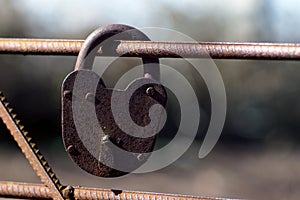 Rusty padlock. Old rusty lock with a key on a nature background, closeup