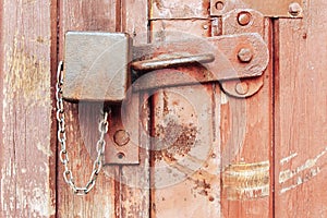 rusty padlock on old wooden door