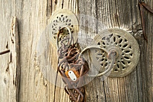 Rusty padlock on wooden door