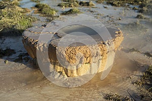 Rusty pipe in ground. Polluter. Evaporation of hot water