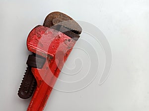 Rusty pipe wrench or monkey wrench isolated on white background