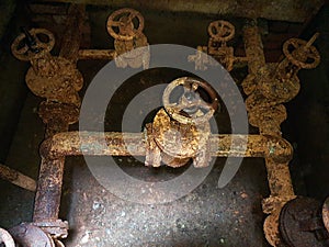 Rusty pipes and valves. Basement of water pumping station. Abandoned post-apocalyptic view of the basement pumping rooms