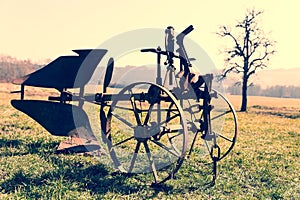 Rusty plow in the field, Vintage filter