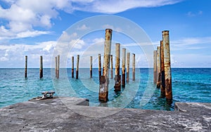 Rusty poles in ruins of old pier