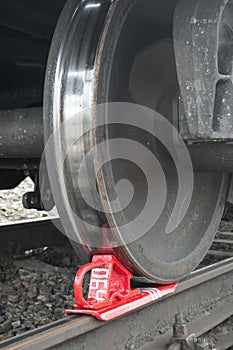 Rusty and polished freight trains wheel on railroad track.