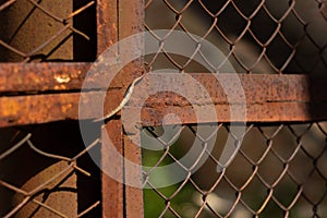 Rusty protective fence, mesh.