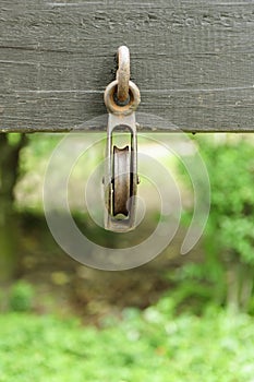 Rusty pulley attached on the wood