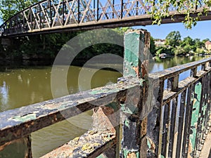 Rusty railings with flakey paint by the river severn