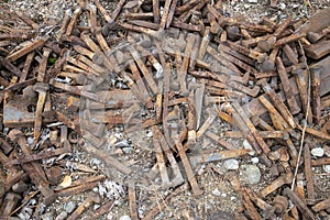 Rusty railroad spikes on ground outdoors