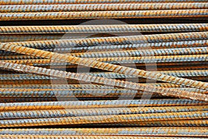 rusty rebar rods lie in a pile near the construction site of the viaduct