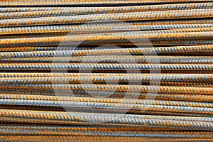 rusty rebar rods lie in a pile near the construction site of the viaduct