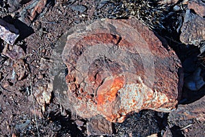 RUSTY RED COLOURED ROCK WITH A WHITE CORE