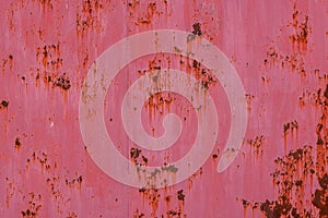 rusty red sun faded paint on flat sheet metal surface full-frame background and texture