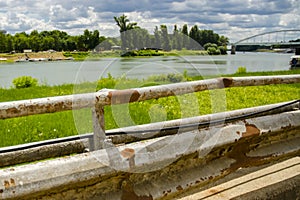 Rusty road railing and the river Tisza at Szeged