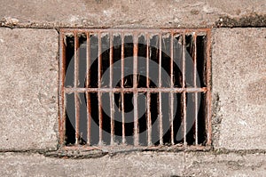 Rusty ruin metal sewage grate iron drainage cover on street top view