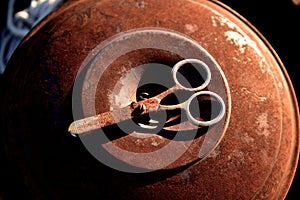 Rusty scissors on a rusty metal can