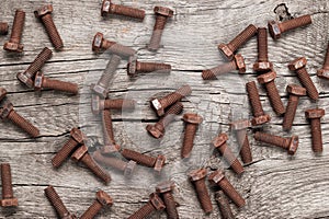 Rusty bolt on the wooden table photo