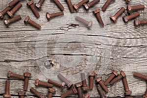 Rusty bolt on the wooden table photo