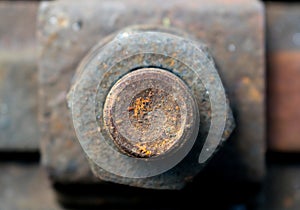 Rusty screw on the raily track-background
