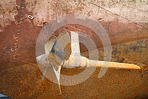 Rusty screw, a shaft and the underwater part of a hull of a ship that dry docked