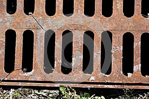 Rusty sewer grate from below