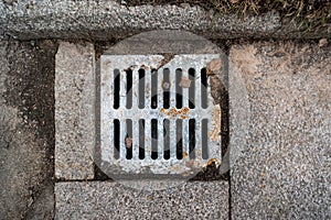 Rusty sewer grate on top