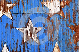 Rusty Sheet Metal With Red, White, and Blue Paint